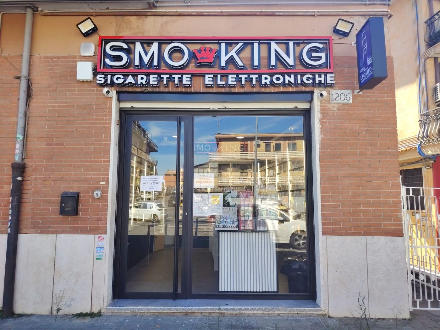 Ingresso del negozio Smo-King di Via Prenestina 1206 a Roma, con insegna Smo-King Sigarette Elettroniche e il civico 1206